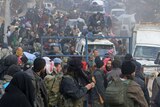 Hundreds of Syrian rebel fighters and civilians gathering for evacuations.