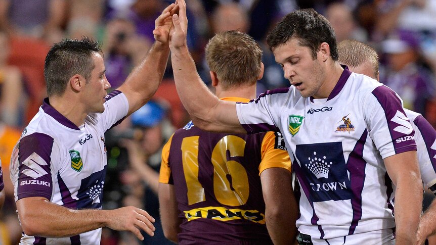 Try-fest ... Matt Duffie (R) scored two for the Storm to hold off the fast-finishing Broncos.