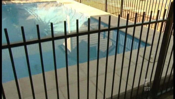 Fence surrounds a backyard pool