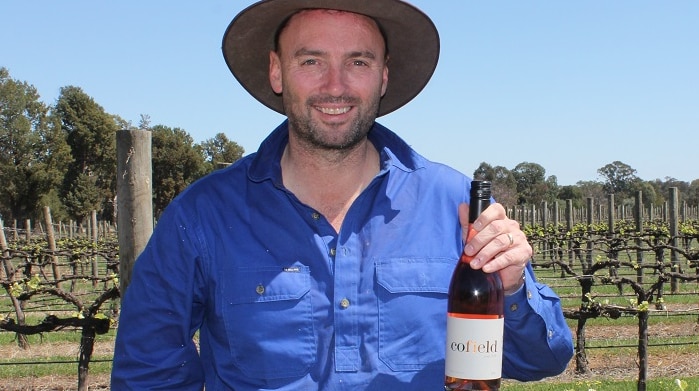Damien Cofield, winemaker at Cofield Wines in Wahgunyah holding award winning 2018 Rosé