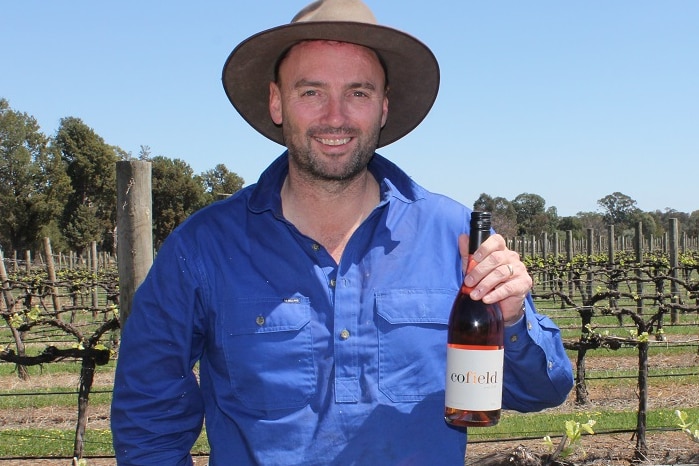 Damien Cofield, winemaker at Cofield Wines in Wahgunyah holding award winning 2018 Rosé