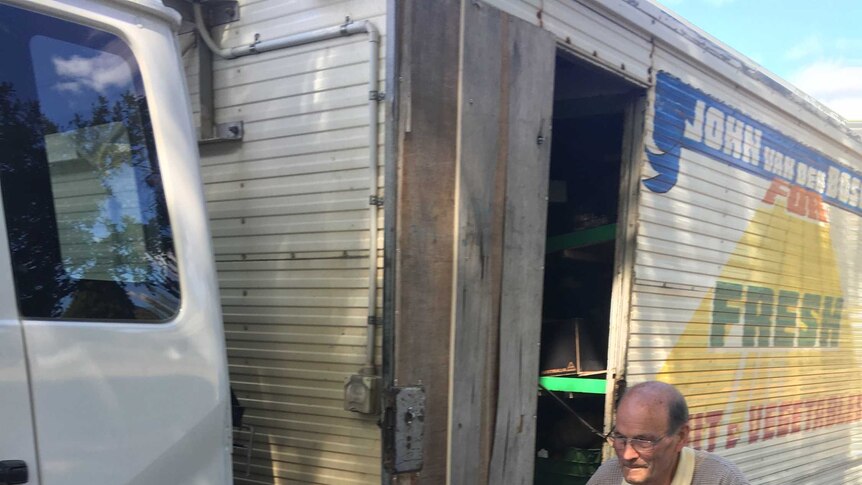 John van den Bosch is loading up his van with fresh fruit and vegetables.