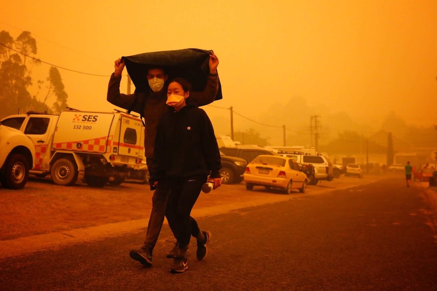 A couple seek refuge in this evacuation centre in Bega, NSW.