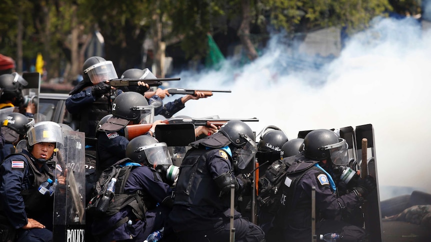 Thai police point guns during anti-government protests in Bangkok