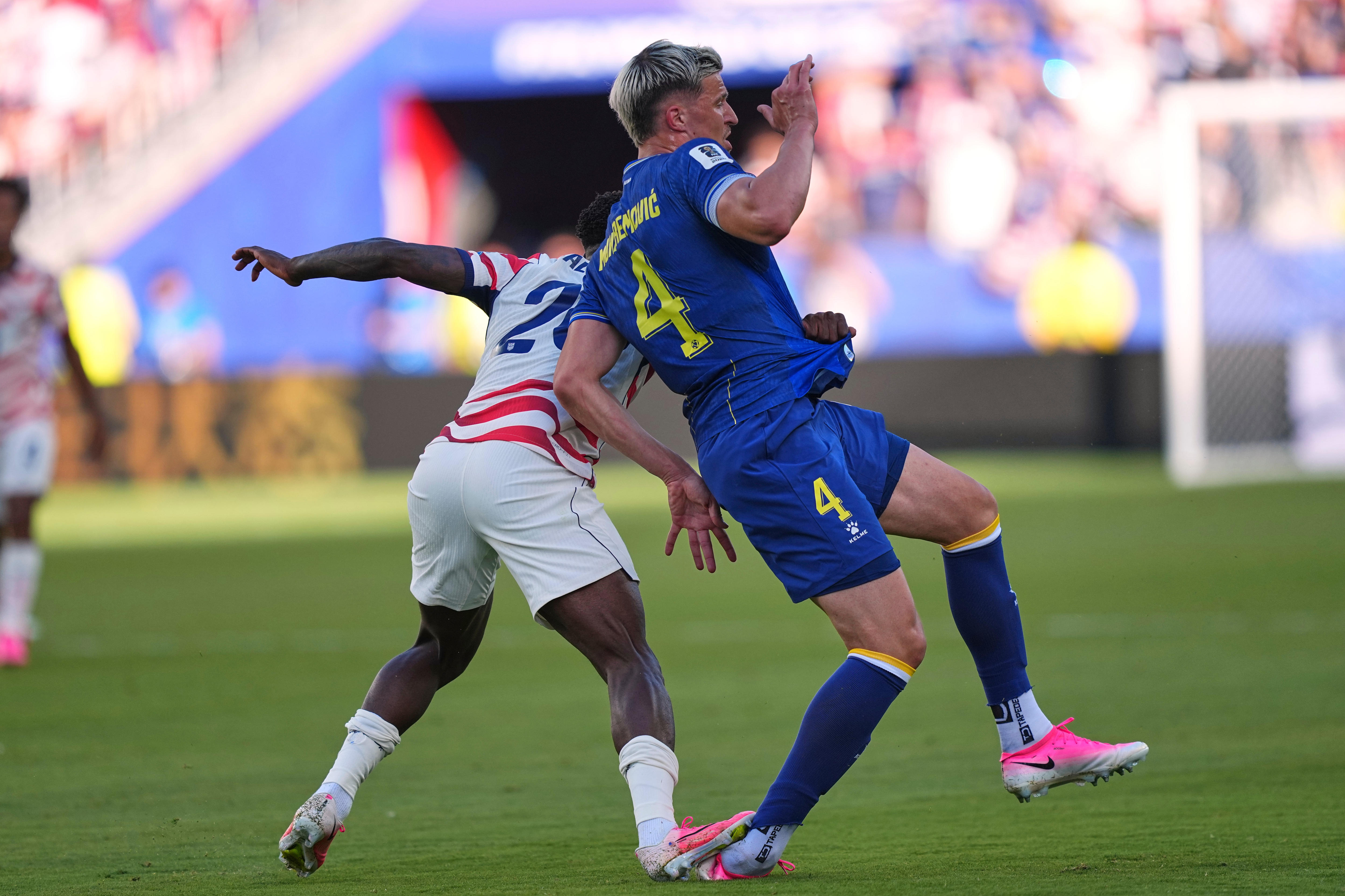 A view of Folarin Balogun with his foot on Tarik Muharemović's ankle.