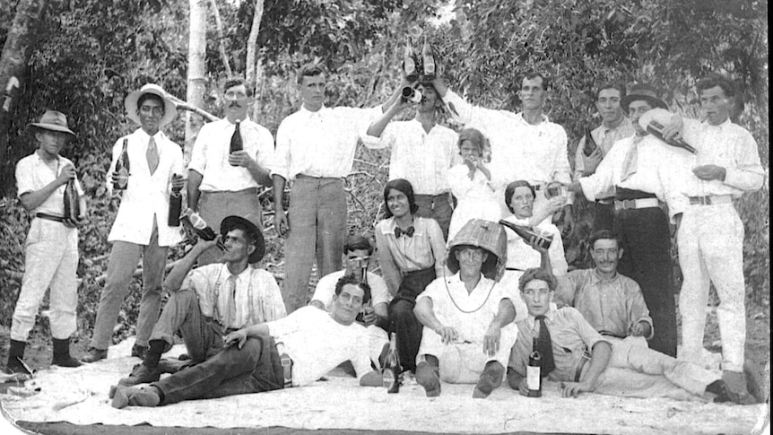 Black and white image of people in bush