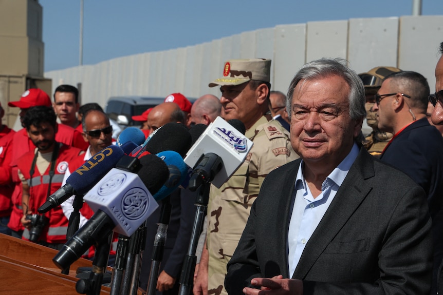 Antonio Guterres stands by press mics at the Rafah crossing. 