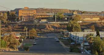 A blurry photo of a mining sight overlooking an outback town.