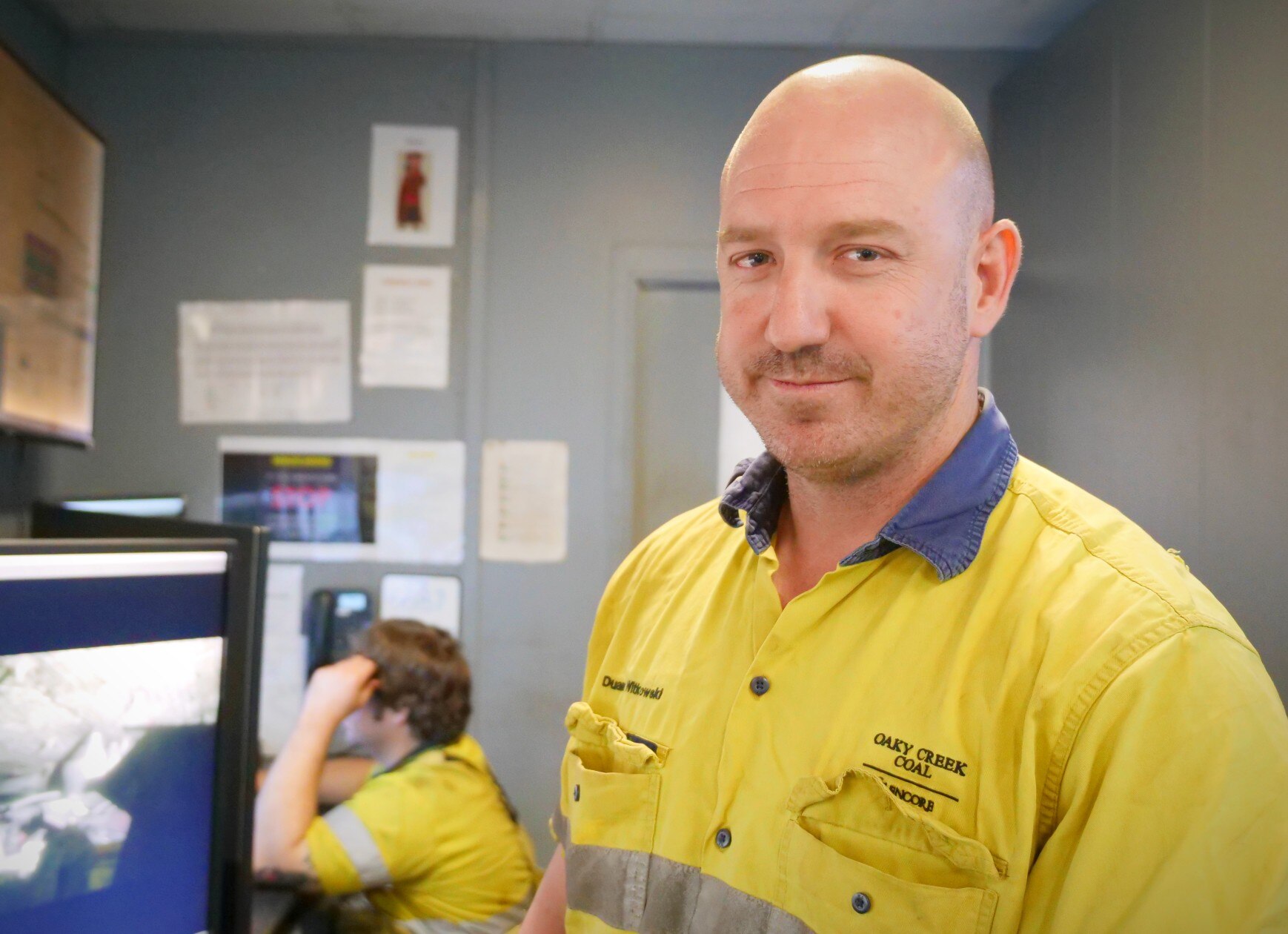 A man in yellow high-vis looking at the camera