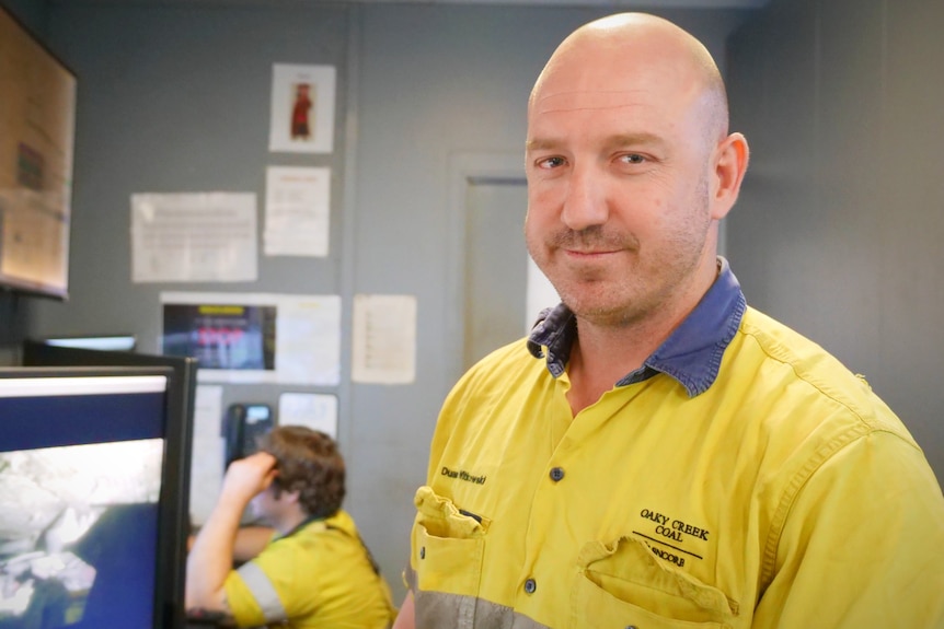 Yellow highly visible man looking at camera