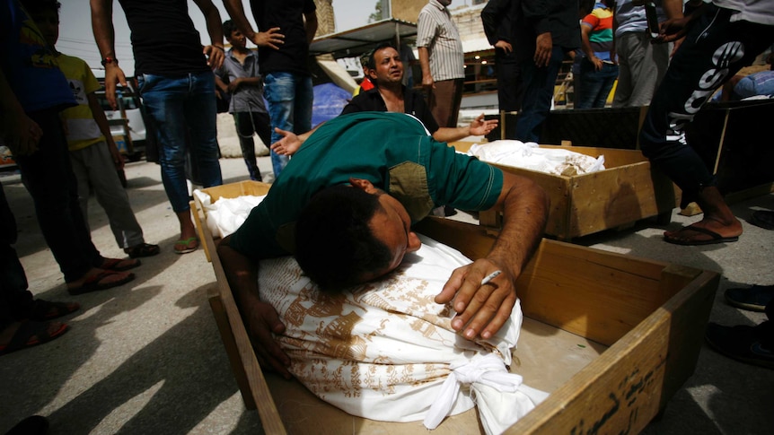 Men mourn family members lost in Baghdad blast