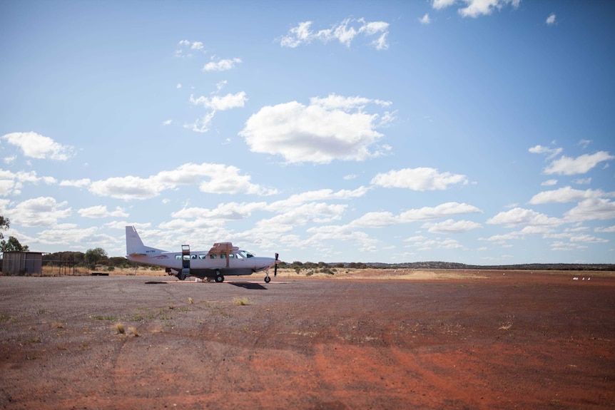 A Chartair plane sits on the runway at Cosmo Newbery, WA.