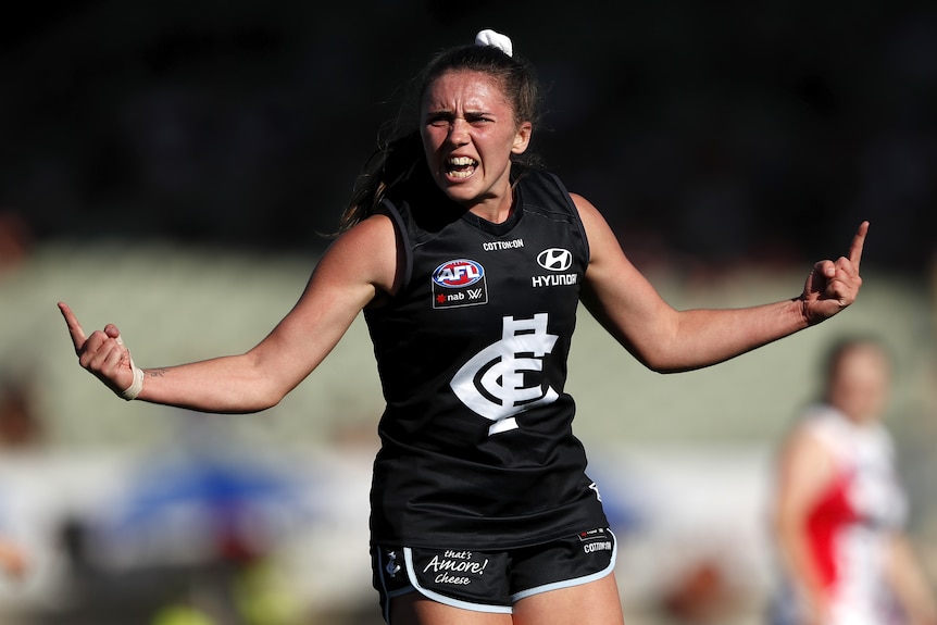 A Carlton AFLW celebrates a goal against St Kilda.