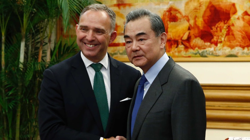 Britain's National Security Adviser Mark Sedwill shakes hands with Chinese Foreign Minister Wang Yi in May 2019.