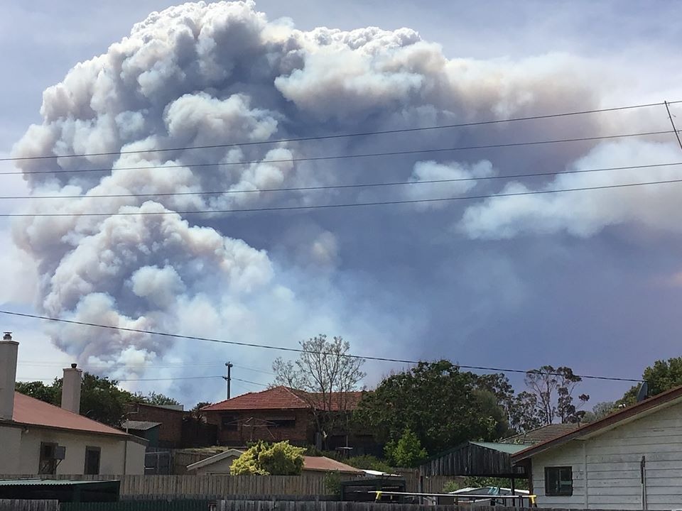 Smoke from a bushfire over houses in Bruthen, Victoria.