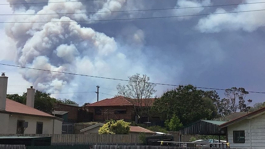 Smoke from a bushfire over houses in Bruthen, Victoria.
