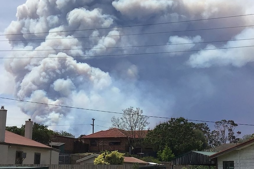 Smoke from a bushfire over houses in Bruthen, Victoria.