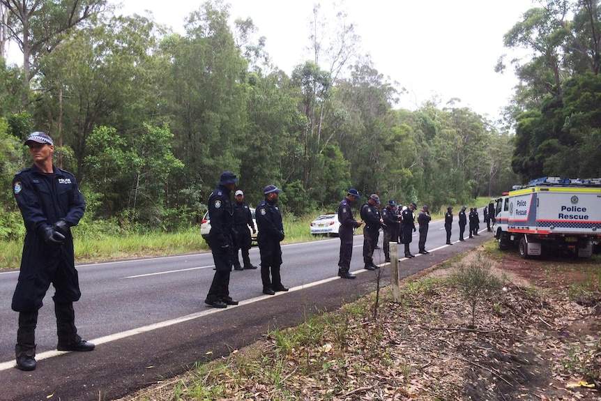 Police begin a grid search at the site at Bonny Hills