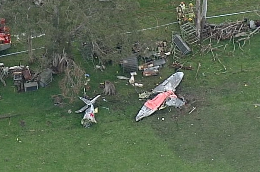 Plane crash wreckage in a paddock.