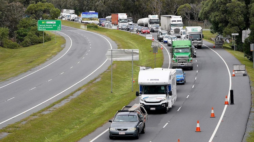 Queue of motorists on the motorway into the Gold Coast approach a checkpoint at Coolangatta on the Queensland-NSW border.