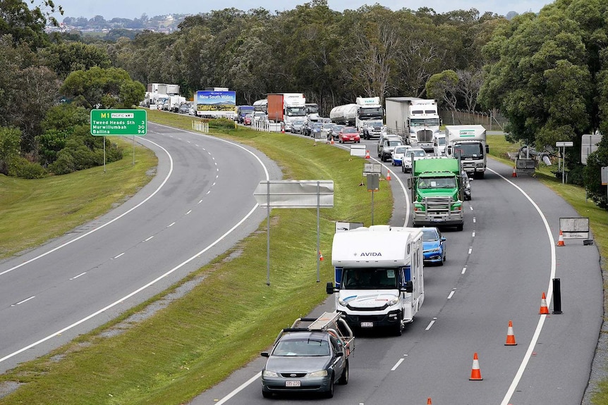 Queue of motorists on the motorway into the Gold Coast approach a checkpoint at Coolangatta on the Queensland-NSW border.