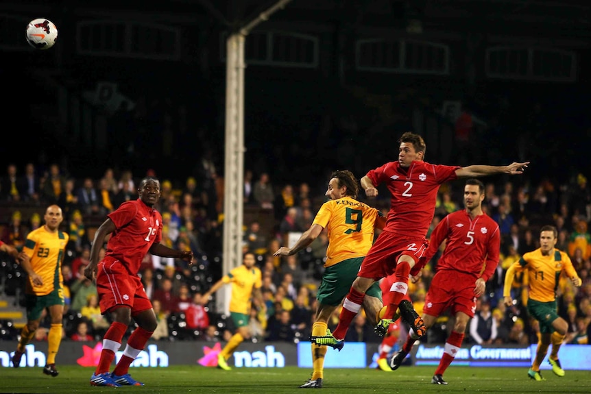 Australia's Josh Kennedy scores the opening goal against Canada at Craven Cottage in London.