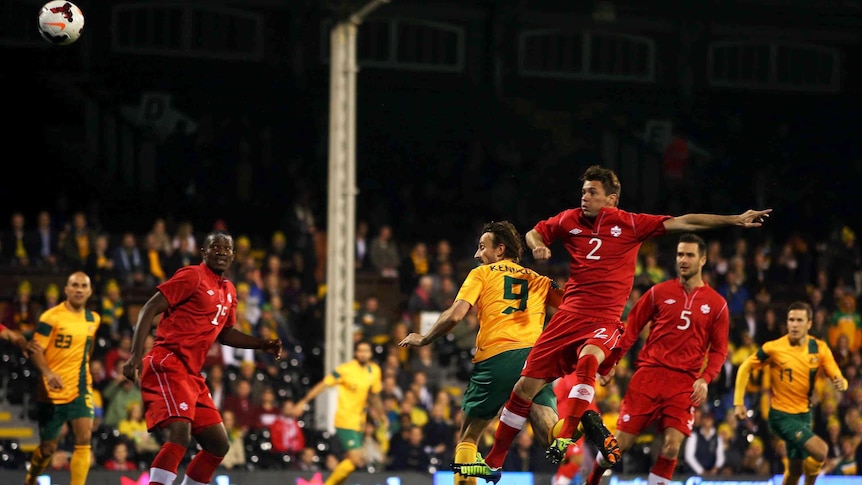 Australia's Josh Kennedy scores the opening goal against Canada at Craven Cottage in London.