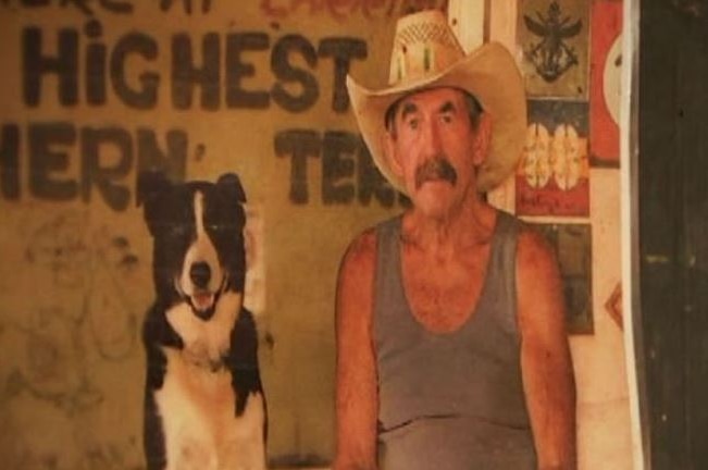Picture of Paddy Moriarty wearing a cowboy hat next to his black and white dog.