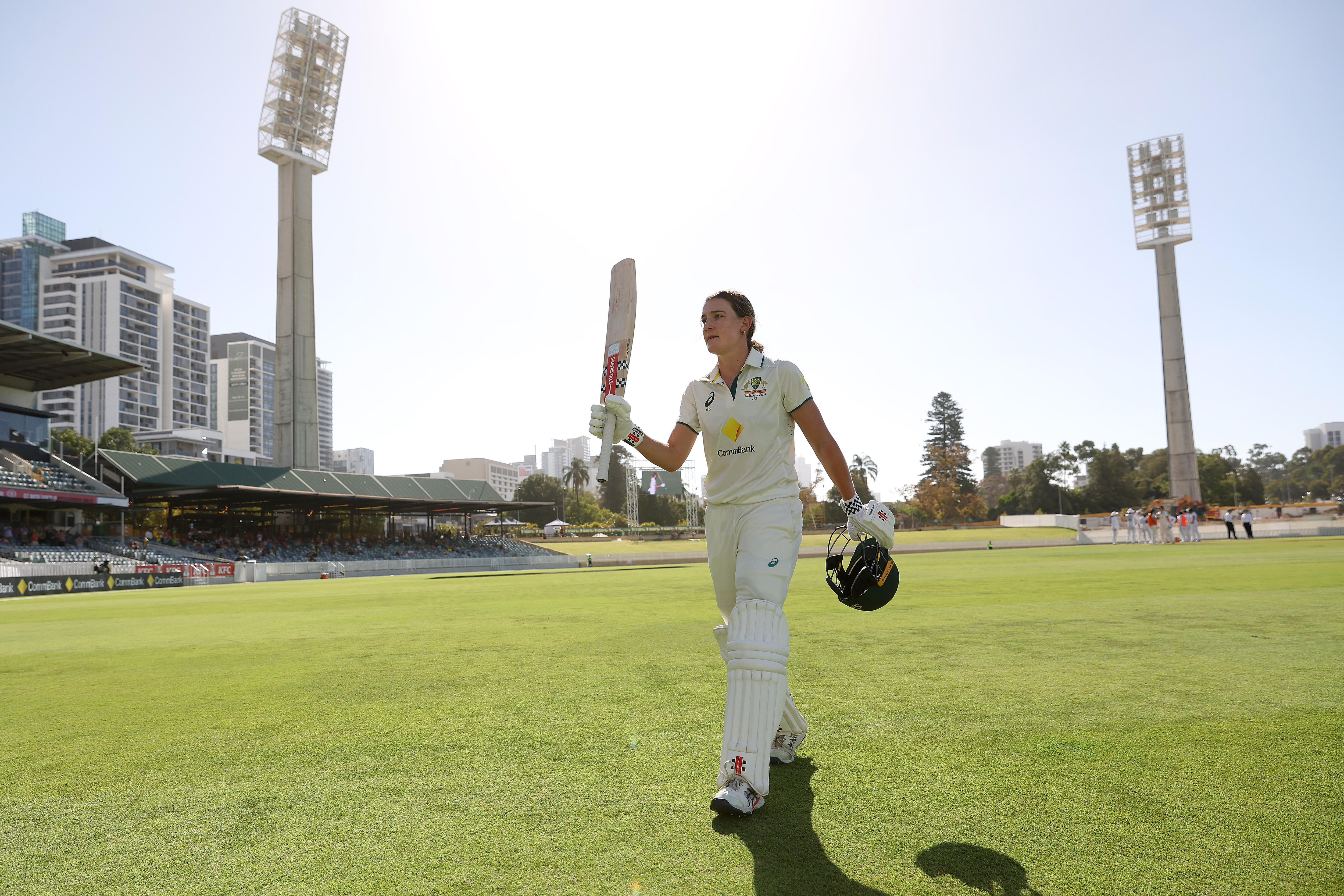 Australia batter Annabel Sutherland raises her bat as she walks off the WACA on day two of the Test against South Africa.
