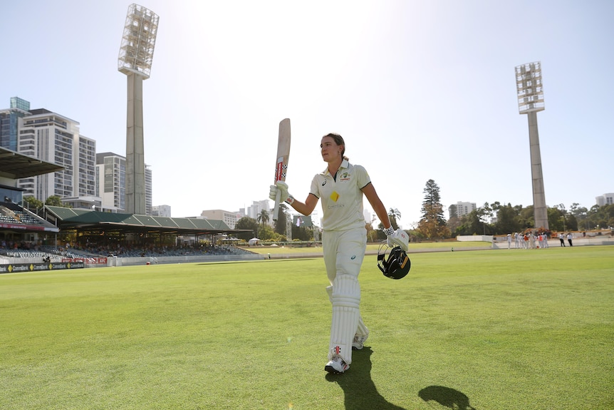 Australia batter Annabel Sutherland raises her bat as she walks off the WACA on day two of the Test against South Africa.