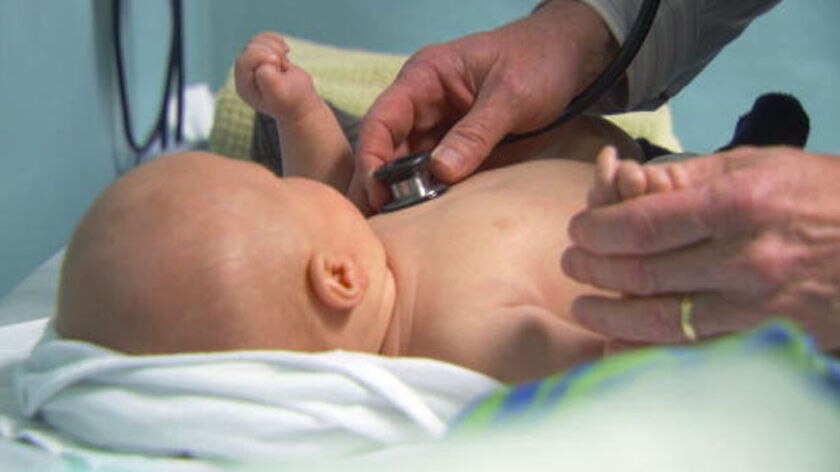 Baby being checked with stethoscope