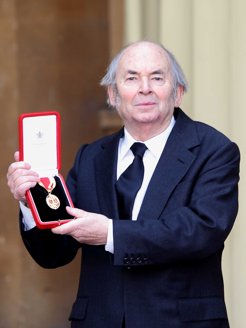 Sir Quentin Blake proudly holds his Knighthood after an the Investiture Ceremony at Buckingham Palace.