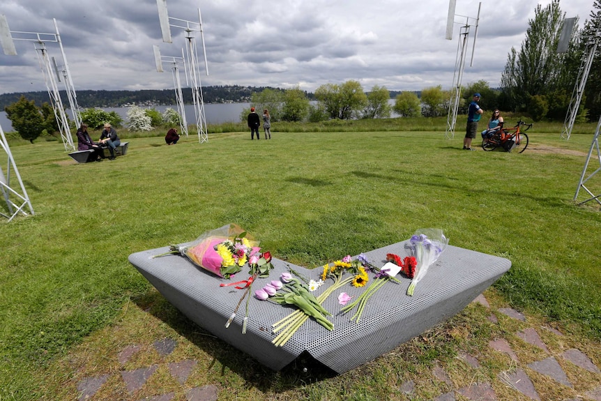 Flowers sit on a bench at the Sound Garden sculpture