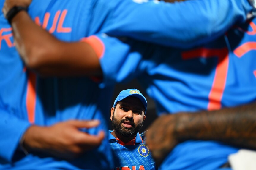 Rohit Sharma speaks in a huddle