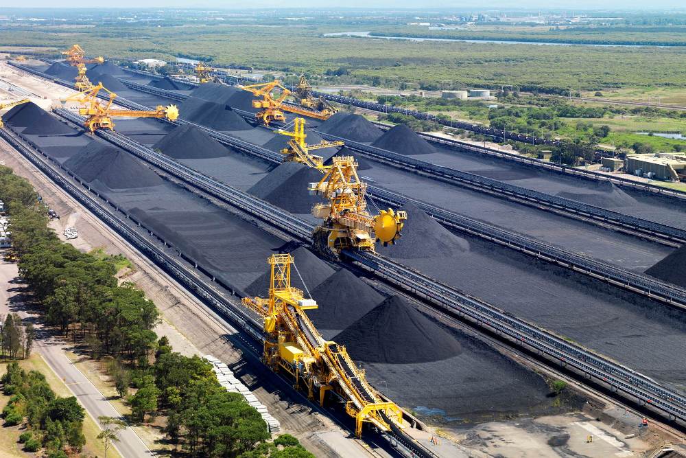 An aerial shot of coal-loading machines on tracks. 
