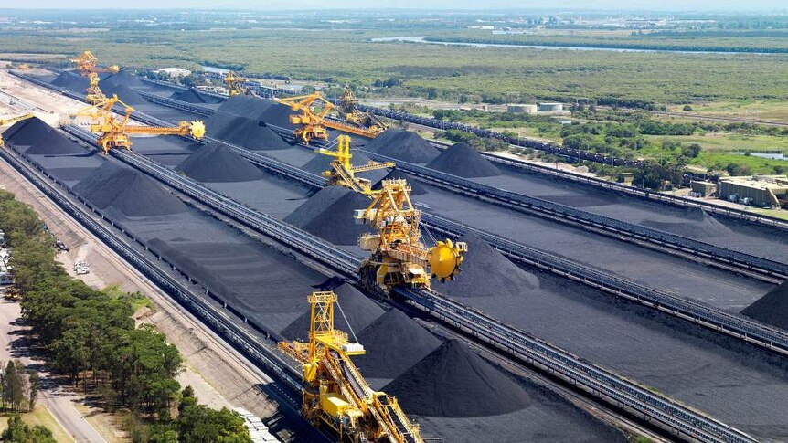An aerial shot of coal-loading machines on tracks. 