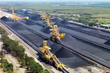 An aerial shot of coal-loading machines on tracks. 