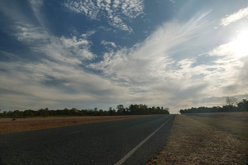 A bitumen road with a huge sky
