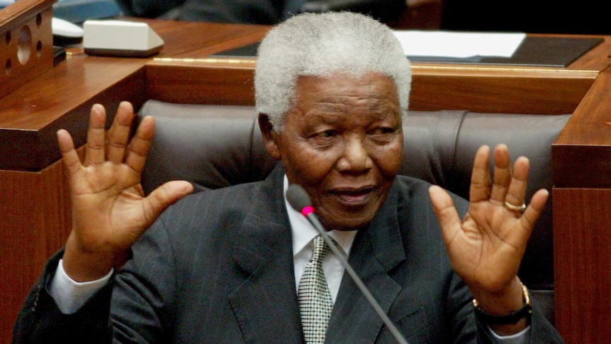 Nelson Mandela waves after his last speech in parliament