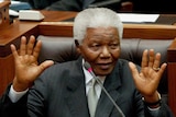 Nelson Mandela waves after his last speech in parliament