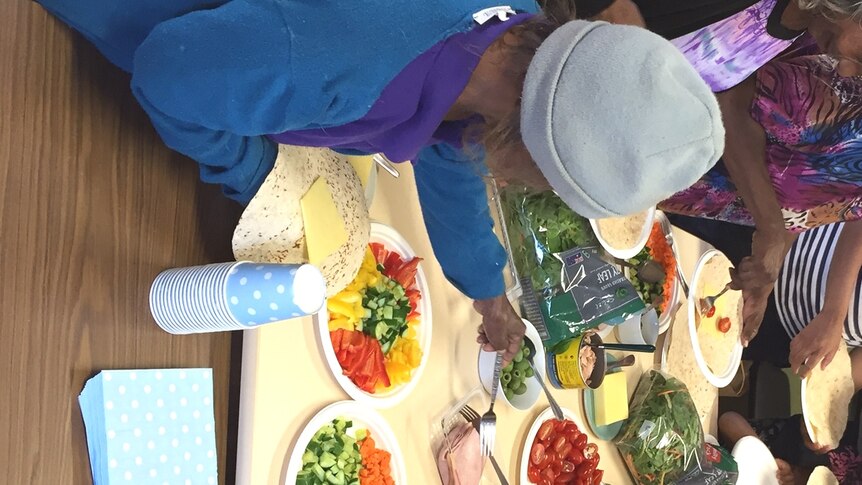 Women make wraps for lunch during a Royal Flying Doctor Service health clinic in Oodnadatta