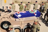 The casket of Sergeant Blaine Diddams is driven outside Camp Russell, Tarin Kot.