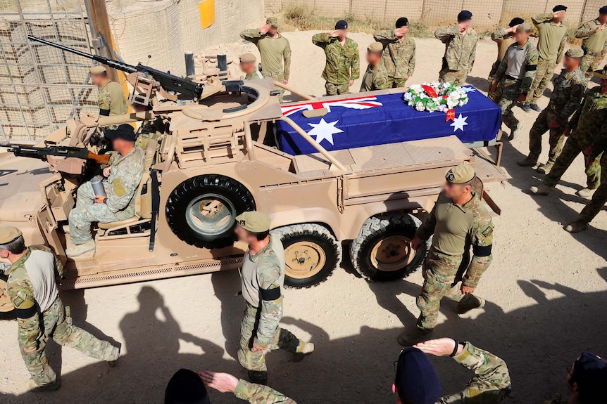 The casket of Sergeant Blaine Diddams is driven outside Camp Russell, Tarin Kot.