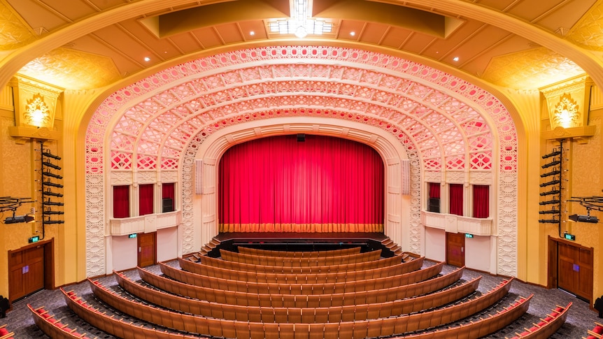 picture of an art deco theatre featuring stage and seats