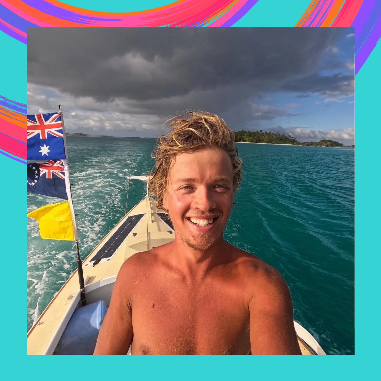Young man with blonde hair no shirt sitting on his boat looking into camera