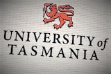 University of Tasmania signage on brick wall.