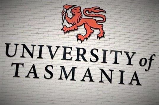 University of Tasmania signage on brick wall.