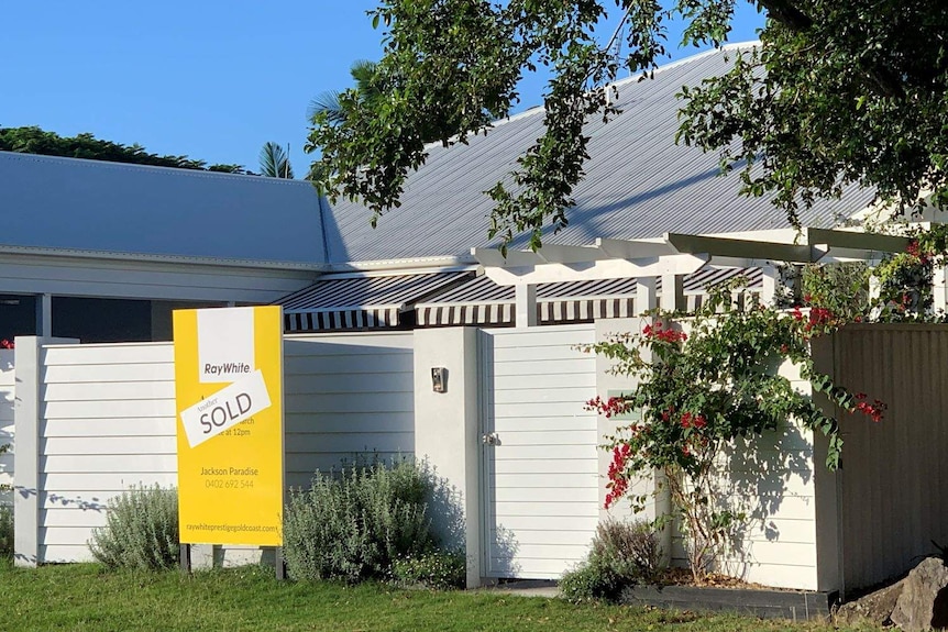 A sold sign out the front of a coastal house in Burleigh Waters.