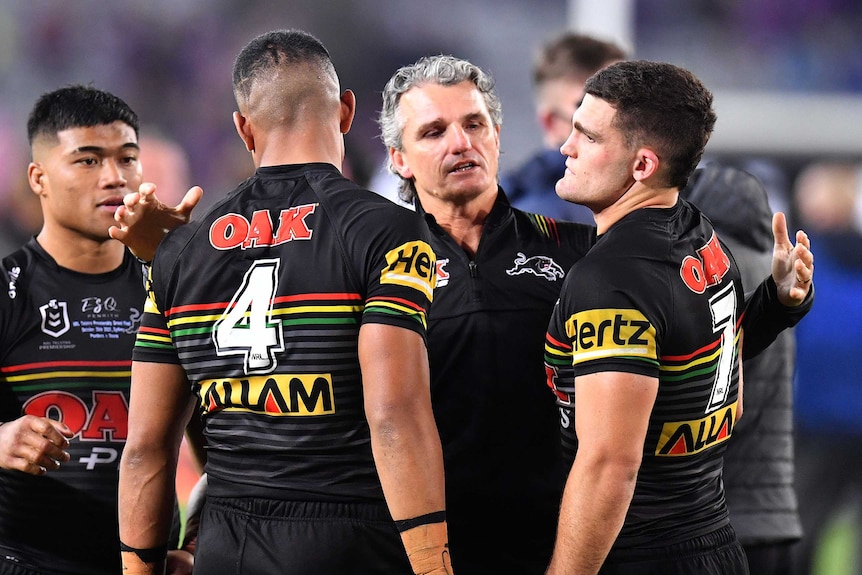 Penrith Panthers coach Ivan Cleary comforts Stephen Crichton and Nathan Cleary after the 2020 NRL Grand Final.