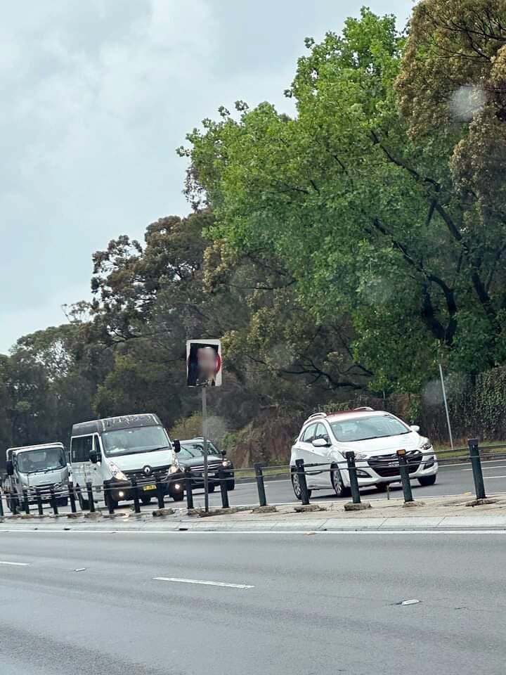 an offensive poster of adolf hitler holding mask of israeli prime minister benjamin nethanyahu on a road sign